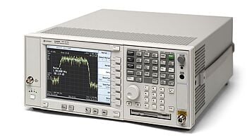 A Keysight E4440A PSA spectrum analyzer showing a signal on its screen.